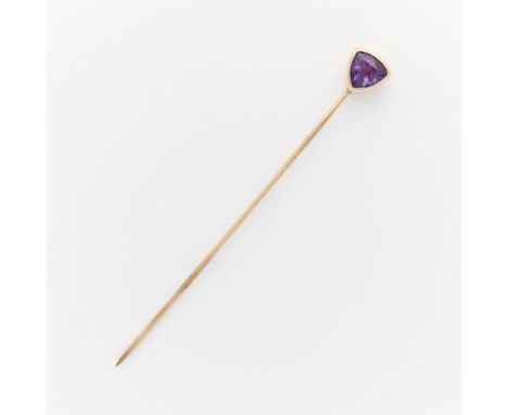 14k yellow gold stick pin surmounted with a bezel set triangular cut amethyst. Unmarked, tested 14k.Length: 56.52 mm. Gross w