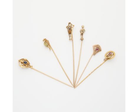 Group of six gold Art Nouveau style stick pins, including:One 14k yellow gold stick pin with Art Nouveau shield shaped filigr