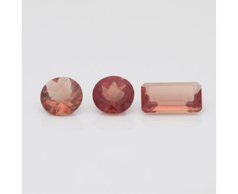 A group of three Spessartine Garnets. Two round cut garnets, 2.10 ctw. One rectangular step cut garnet, 1.65 ct.(Step cut) Le