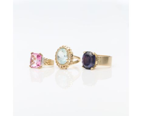Group of three cocktail rings including:14k yellow gold ring set with radiant cut pink synthetic stone and six round full cut
