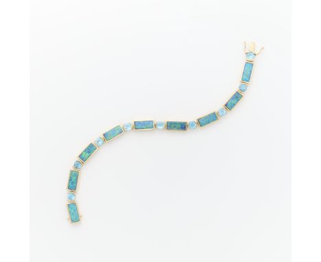 14k yellow gold bracelet set with nine round blue topazes set in semi bezels, alternating with rectangular links set with sla