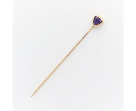 14k yellow gold stick pin surmounted with a bezel set triangular cut amethyst. Unmarked, tested 14k.Length: 58.75 mm. Gross w