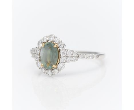 Platinum alexandrite and diamond ring. Set in yellow gold with central oval cut alexandrite (color change from blueish green 