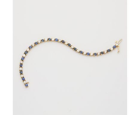 14k yellow gold bracelet set with sapphires and diamonds in three prong settings. Set with 20 round brilliant sapphires alter