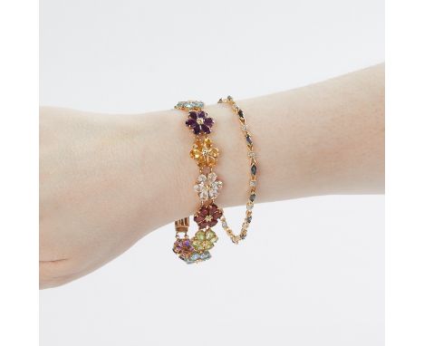 One 14k yellow gold plated bracelet; with maker marks SLV along the underside. With alternating flowers comprised of amethyst