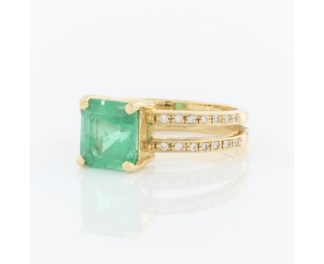 18k yellow gold ring set in a four prong setting with central square step cut emerald of approximately 2.08 carat. On a split
