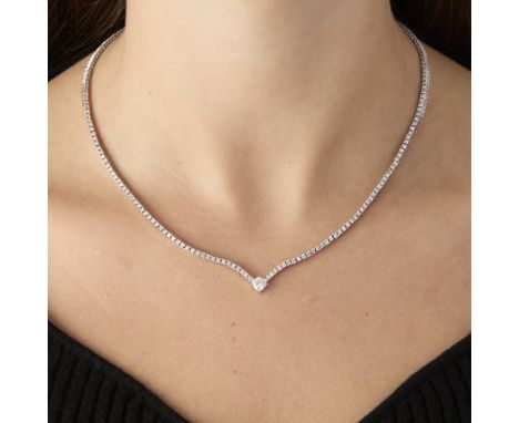 18k white gold and diamond tennis necklace. Comprised of 211 round brilliant cut diamonds of F to H color and VS-2 to SI-2 cl