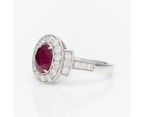 Oscar Friedman platinum Burmese ruby and diamond ring. Set with central oval cut Burmese ruby of 1.13 ct. Surrounded by a hal