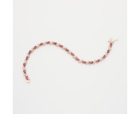 14k yellow gold bracelet set with marquise cut rubies and accent single cut diamonds. With 19 marquise cut rubies set at an a