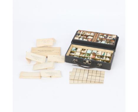 Two boxes of semi-precious gemstones. One black case with two layers of partitions; guide cards list zircon, peridot, synthet