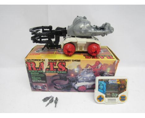 A boxed Tomy R.A.T.S. Robot Anti-Terror Squad 'Grapplor' vehicle (missing some turrets, losses to box), and a Tiger Electroni