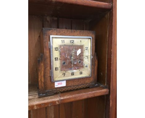 AN OAK MANTEL CLOCK