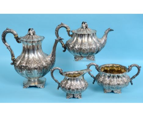 A William IV silver four piece tea and coffee service, of lobed form, decorated flowers and foliage, the coffee pot containin