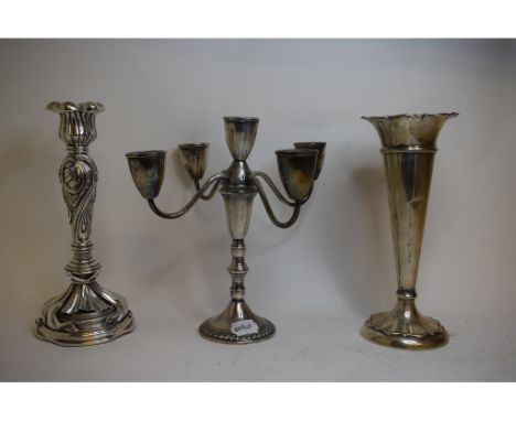 A sterling silver five light candelabrum, 24 cm high, a silver trumpet shape vase, marks rubbed, repaired, 25 cm high, and an