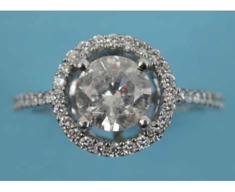 A 14ct white gold and diamond ring, the central brilliant cut stones within a diamond halo, the pierced mount set diamonds an