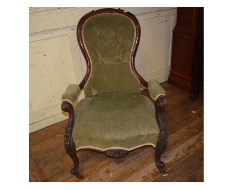 A Victorian rosewood button back armchair, on cabriole front legs