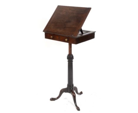 A George III mahogany reading stand, the adjustable top above a frieze drawer, on a rise and fall stand and tripod base, 53 c