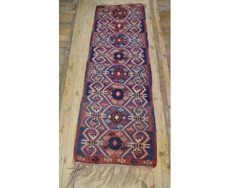 A Turkish Kelim runner, decorated eight medallions on a light blue ground, 236 x 77 cm  