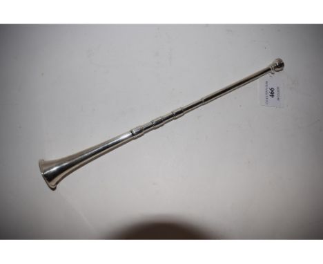 A silver candle extinguisher, in the form of a hunting horn, London 1912, 30.5 cm long