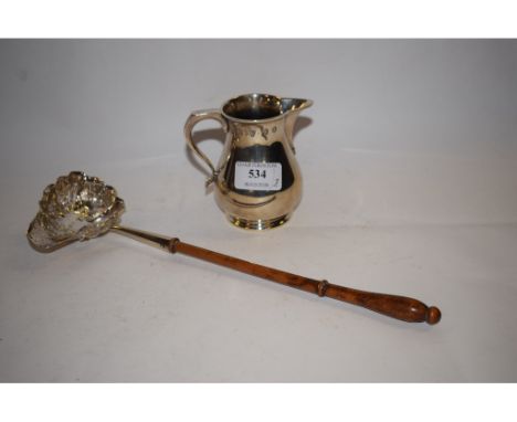 A silver cream jug, Chester 1935, approx. 6.6 ozt, and a toddy ladle, with a turned wood handle (2) 
