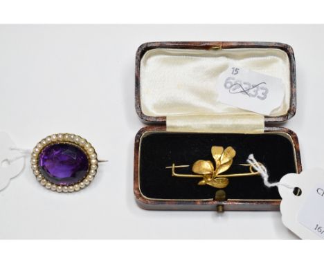 An oval amethyst and pearl brooch, and a yellow coloured metal mistletoe bar brooch, approx. 2.8 g (2)   Condition report  Re