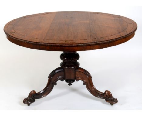 A 19th century rosewood centre table, with cut brass inlay, on a baluster carved column and tripod base, 122 cm diameter  See