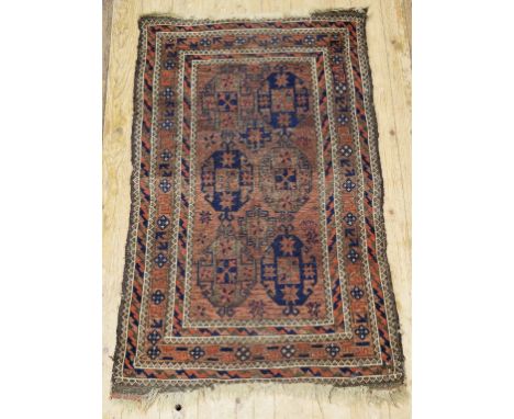 A Baluch rug, decorated medallions on a light brown ground, within a multi border, 133 x 85 cm 