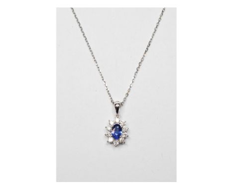 An 18ct white gold, sapphire and diamond cluster pendant, on a 18ct white gold chain