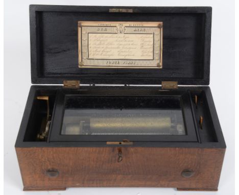 A lever wind music box, the 15 cm cylinder playing six airs, in an oak case, 35.5 cm wide  See illustration   Condition repor