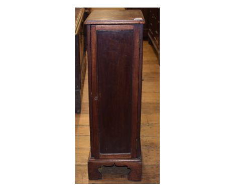 A collectors mahogany cabinet, the panel door enclosing eight graduated long drawers, on bracket feet, 29 cm wide 