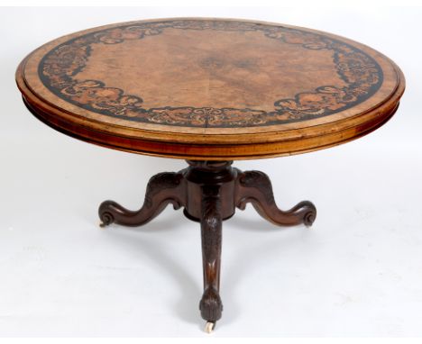 A Victorian centre table, the top quarter veneered in walnut and inlaid with a border of grotesque masks, mythical beasts, fl