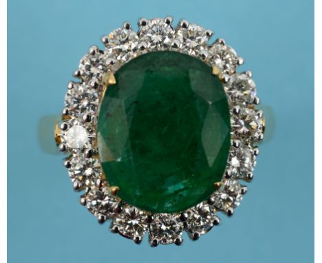 An 18ct gold, oval emerald and diamond cluster ring, approx. ring size M½  See inside front cover colour illustration   Condi