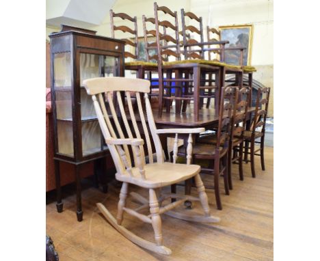 A set of ten fruitwood ladder back dining chairs (8+2), a mahogany extending dining table, having an extra leaf, a pine rocki