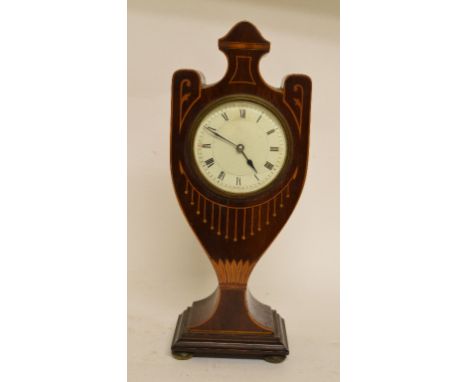 An Edwardian mantel clock, the 19 cm diameter enamel dial with Roman numerals, in an inlaid mahogany vase shaped case, 32.5 c