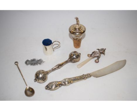 A modern silver mounted decanter stopper, with a lady golfer finial, two children's rattles, a cigar cutter, and other items 