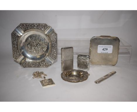 A silver Howitt lighter, initialled, Sheffield 1943, a silver vesta case, a silver ingot pendant, two silver colour metal ash