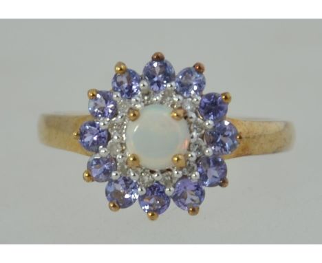 A 9ct gold / 375 marked amethyst and opal ladies dress ring. The central round cut opal with amethyst surrounds. Size p.5 / W