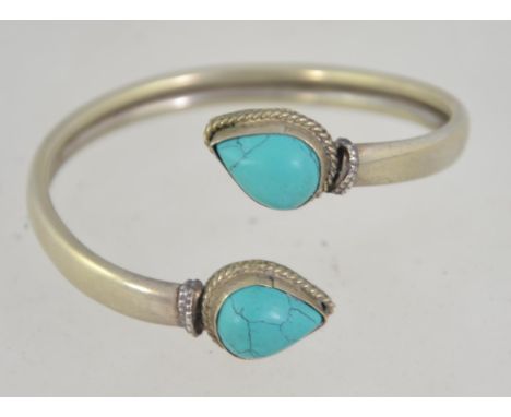 A vintage 20th century ladies silver and turquoise wrap bangle being marked 925 / 6cms diam