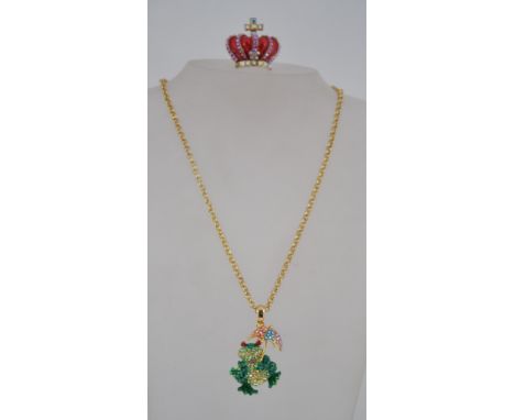 A Butler & Wilson enamel set front pendant and necklace chain together with a rhinestone set ring in the form of a Crown by B