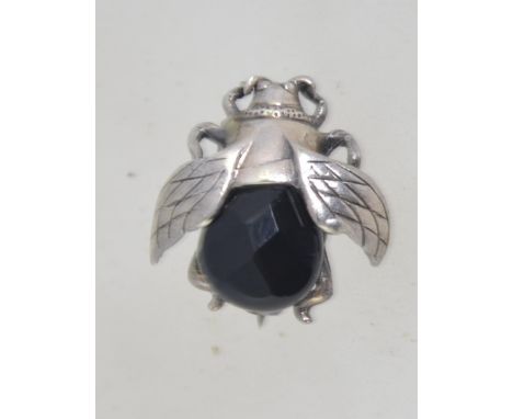 A vintage white metal bug brooch with faceted french jet abdomen and roller clasp. Measures 2cms.