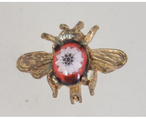 A vintage gold tone bug brooch pin with Murano glass body and roller clasp. Measures 2.5cms.