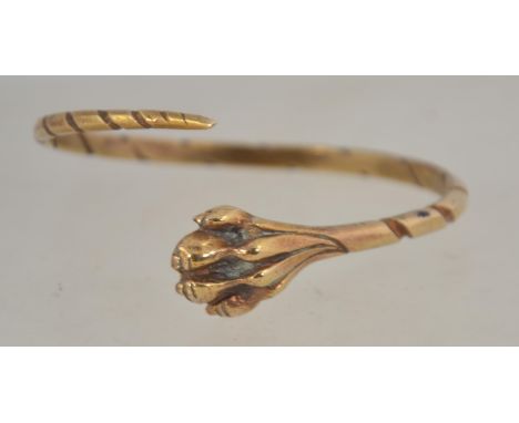 A vintage yellow metal lions paw wrap around bangle