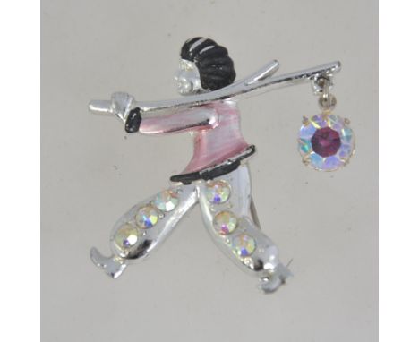 A 1950's silver tone enamel figural brooch pin set with aurora Borealis rhinestones of a figure carrying a cane with dangle r