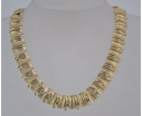 A vintage gold tone choker necklace with textured U links and hook clasp with ball final. Maximum length 17.5inches.