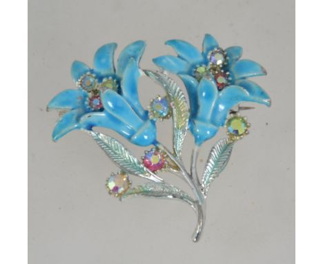 A vintage 1950's silver tone and enamel figural brooch pin of a spray  of flowers set with Aurora Borealis rhinestones with C