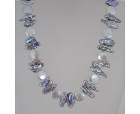 A vintage baroque freshwater pearl necklace having large white and grey pearls with gold tone and toggle fastening. 50cms