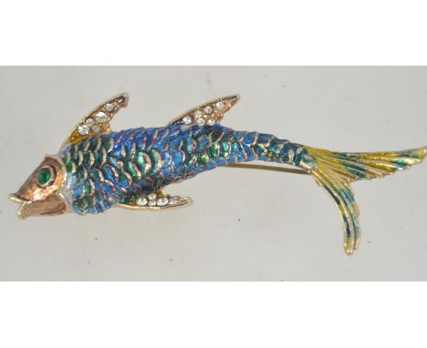 A 1960's enamel and rhinestone brooch in the form of a fish having a gold tone setting with rollover catch. 8cms long