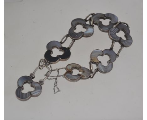 An unusual vintage silver and agate bracelet with pieced agate set trefoil links with trefoil lock with safety chain. Measure