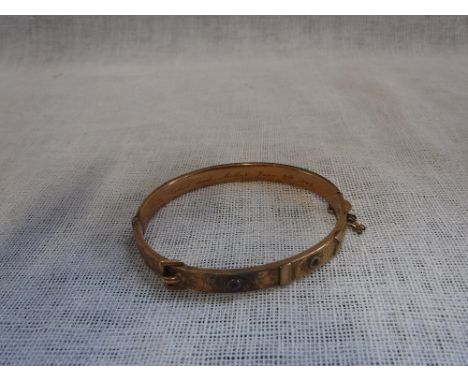 A 9CT YELLOW GOLD BANGLE, with safety chain