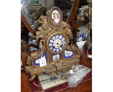 A 19TH CENTURY GILT SPELTER MANTEL CLOCK with inset porcelain panels, 12.5" high